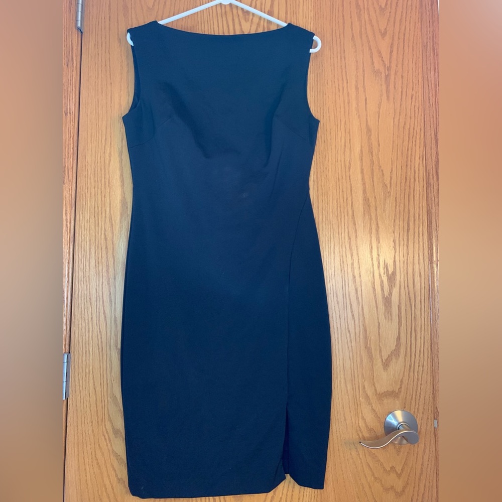 Flattering collar neckline & lower back, lined form fitting cocktail black.